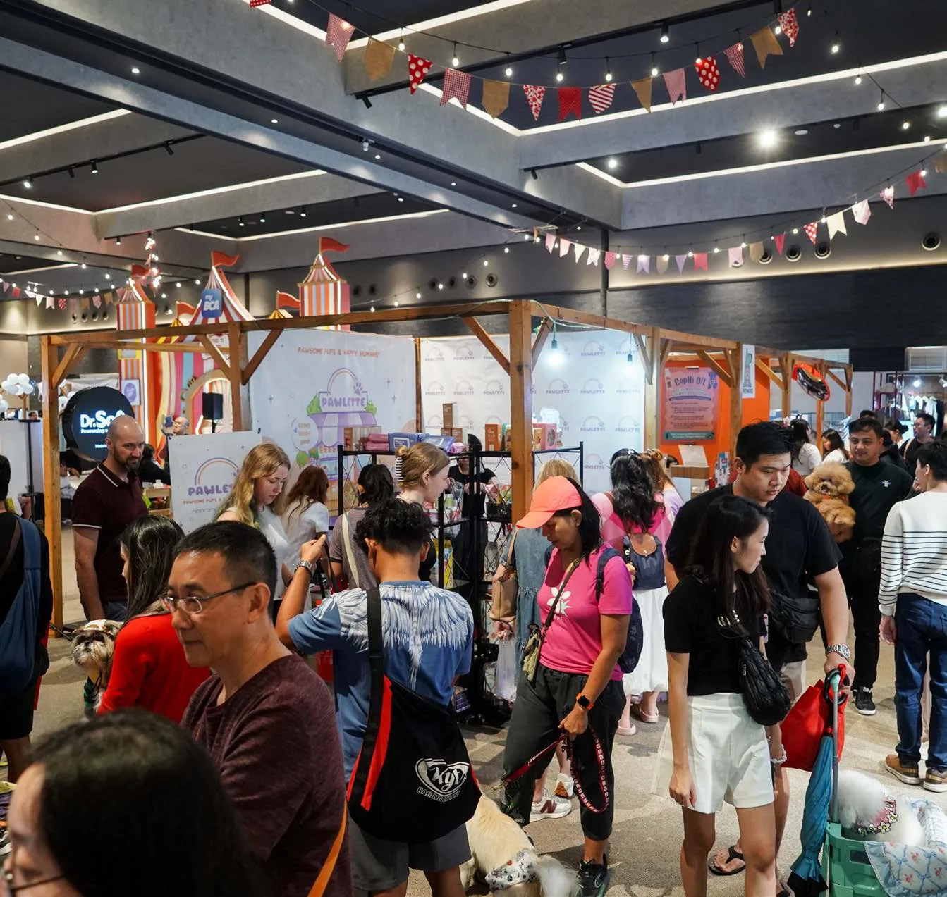 Visitors exploring pet brand booths at an earlier event