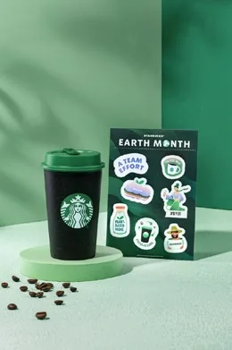 Starbucks tumbler and food on a green Earth Month set